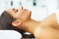 Beauty. Young Girl in Beauty Salon. Brunette Woman with Green Eyes. Lying on the Massage Tables. Clean and Fresh Skin