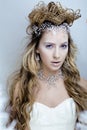 Beauty young snow queen with hair crown on her head, complicate hairstyle, winter concept Royalty Free Stock Photo