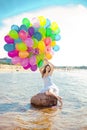 Beauty young stylish woman with multi-colored rainbow balloons i Royalty Free Stock Photo