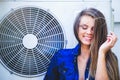 Beauty young woman with air conditioning. near the fan happy laughing. Long hair. Fashionable lady with a beautiful hairdo, makeup Royalty Free Stock Photo