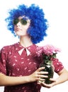 Beauty young woman in a blue wig with flowers