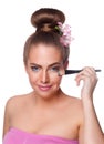 Beauty young woman brushing concealer under eyes