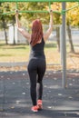 Beauty young woman chin ups in park