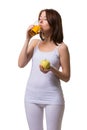 Beauty young woman drinks apple juice from glass a