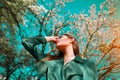 Beauty young woman enjoying nature in spring apple orchard, Happy beautiful girl in a garden with blooming fruit trees Royalty Free Stock Photo