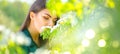 Beauty young woman enjoying nature in spring apple orchard, Happy beautiful girl in a garden with blooming fruit trees