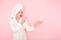 Beauty Young woman with red lips standing in the bath robe on the pink background Royalty Free Stock Photo