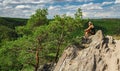 Beauty young woman sit on rockfrom side. Outdoor, fitness concept. national park Podyji, Czech republic