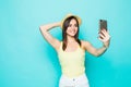 Beauty woman is taking photo self portrait on a smartphone in the city closeup screen over colorful green background