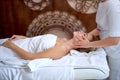 Beauty and youth. Hands of the masseuse make massage for relaxed charming woman