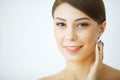 Beauty Youth Skin Care Concept - Close up Beautiful Caucasian Woman Face Portrait applying some cream to her face for skin care. Royalty Free Stock Photo