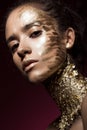 Beautyful girl with gold glitter on her face. Art image beauty