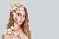 Beautyful girl with tulip flowers in her hair, petals and color painting on her body. Cosmetic, beauty and make-up.