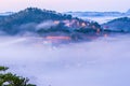 Da lat, lam dong, viet nam- feb 12, 2017: beautyful landscape of da lat city, a small vietnamese pagoda in fog and the pine hill Royalty Free Stock Photo