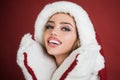 Beautyful sensual model girl in santa hat. Christmas smiling woman. Portrait of smiling woman isolated on red background. Portrait