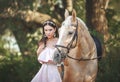 Beautyful woman in dress with horse