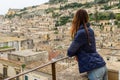 Beautyful woman looking on Modica old baroque town