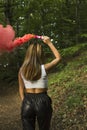 Woman with pink smoke bomb in the woods Royalty Free Stock Photo