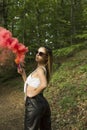 Woman with pink smoke bomb in the woods Royalty Free Stock Photo