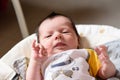 Bebe with yellow and white body lying on baby hammock Royalty Free Stock Photo