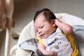 Bebe with yellow and white body lying on baby hammock Royalty Free Stock Photo