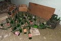 Abandoned bottles of beer. Empty glass alcohol bottles. Dusty bottles on the floor in an abandoned house