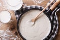 Bechamel sauce in a pan and milk on the table top view