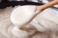 Bechamel sauce with a wooden spoon close-up, horizontal