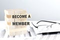 BECOME A MEMBER is written on wooden blocks on a chart background Royalty Free Stock Photo