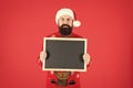 Become professional Mr Santa Claus. Bearded man hold empty blackboard. Hipster santa red background. Attend Santa school