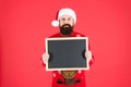 Become professional Mr Santa Claus. Bearded man hold empty blackboard. Hipster santa red background. Attend Santa school