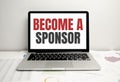 become a sponsor word on the laptop display. concept