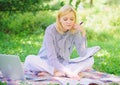 Become successful freelancer. Woman with laptop sit on rug grass meadow. Girl with notepad write note. Business lady