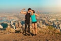 Become a workout power couple. Full length shot of a young couple flexing their muscles and kissing while out for a