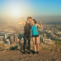 Become a workout power couple. a young couple flexing their muscles while out for a workout.