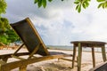 Bed beach and wood table under tree and on the beach Royalty Free Stock Photo