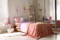 Bed with beautiful linens in children`s room