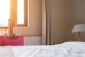 A bed in the bedroom of a hotel room and a suitcase by the balcony Royalty Free Stock Photo