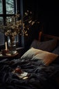 Bed With Black Comforter and Vase of Flowers