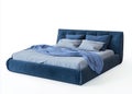 A bed with a blue headboard and pillows on top of it Royalty Free Stock Photo