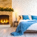 Bed with blue pillows and coverlet near fireplace against white brick wall. Loft, scandinavian interior design of modern bedroom Royalty Free Stock Photo