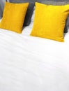 Bed with bright yellow velveteen cushions