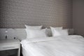 Bed, clean pillows and bed sheets in modern bedroom hotel Royalty Free Stock Photo