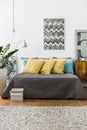 Bed with decorative yellow pillows