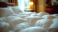 inviting hotel bed with fluffy white comforter Royalty Free Stock Photo