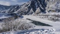 The bed of the frozen river has partially thawed.