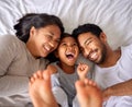 Bed, fun and happy family playing, wake up and happy from above, tickle and laughing in their home. Bedroom, games and Royalty Free Stock Photo