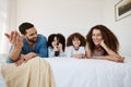 Bed, happy family children and parents watching tv series, movies or online streaming service, entertainment or video Royalty Free Stock Photo