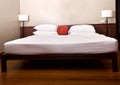 Bed and headboard in bedroom with lamp. Royalty Free Stock Photo