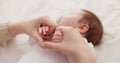 Bed, holding hands and mother with baby, love and support for care, health and wellness at home. Fingers, family or mama Royalty Free Stock Photo